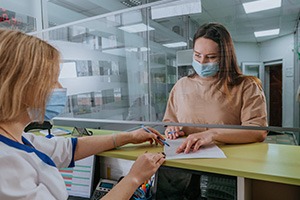 Patient in Fort Worth talking to dental team about root canal affordability