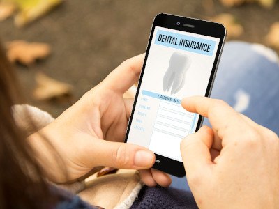 Closeup of a phone with dental insurance information on it