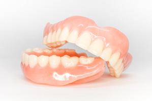 Full set of dentures on a white background