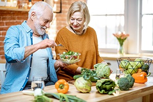 A senior couple having fun in the kitchen with healthy foods