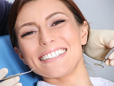 Smiling woman getting dental checkup