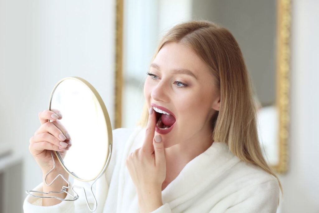 Woman looking at her teeth in the mirror